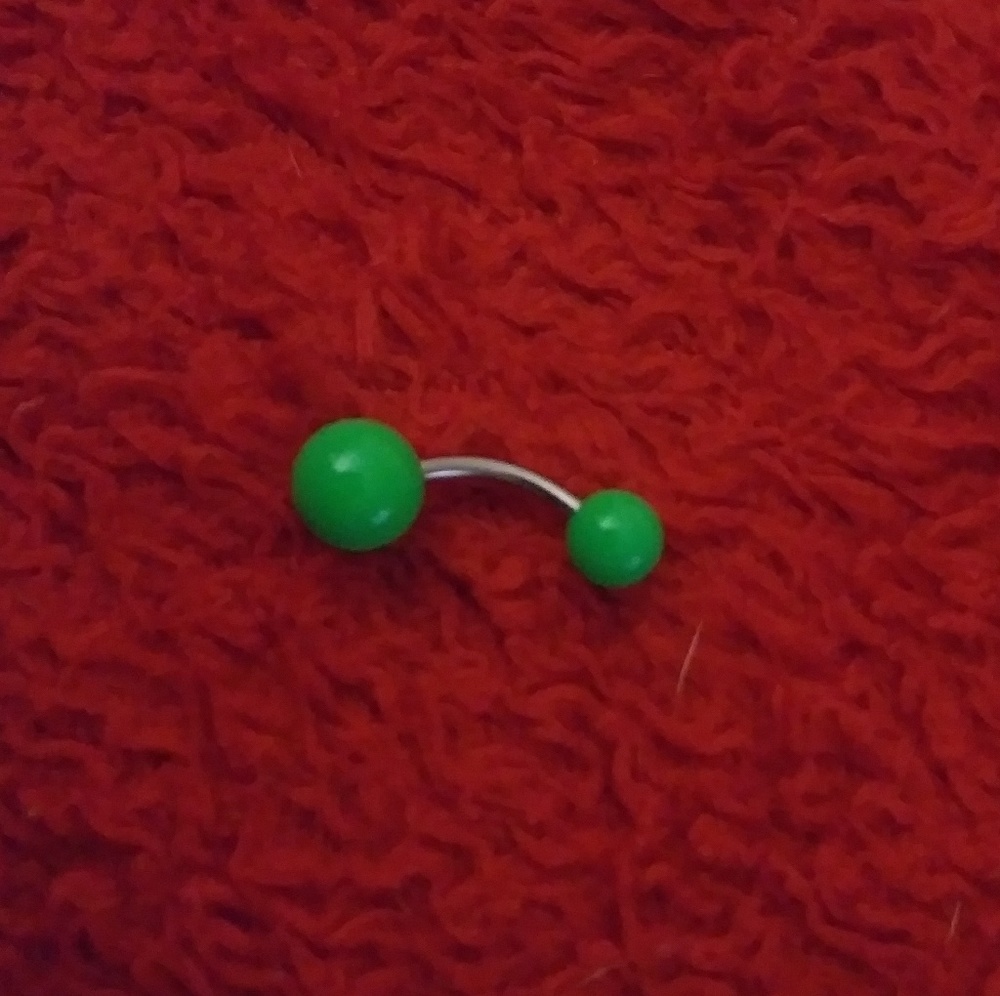 Green belly button piercing